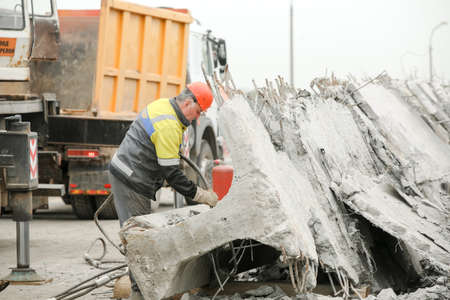 MINSK, BELARUS - 18 FEBRUARY, 2022: workers dismantle and repair the bridgeの写真素材