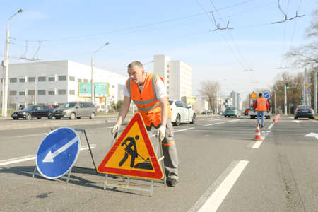 MINSK, BELARUS - 18 FEBRUARY, 2022: workers apply road markings on the roadのeditorial素材