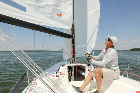 MINSK, BELARUS - 22 July, 2022: girl is sailing on a boatの写真素材