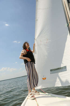 MINSK, BELARUS - 22 July, 2022: girl is sailing on a boatの写真素材