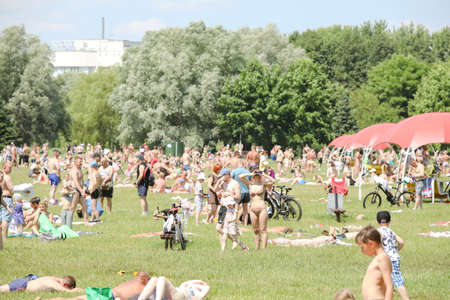 MINSK, BELARUS - 22 July, 2022: people sunbathing on the beach by the lake in the cityの写真素材