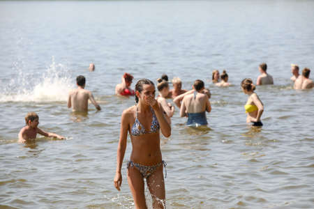 MINSK, BELARUS - 22 July, 2022: people sunbathing on the beach by the lake in the cityの写真素材