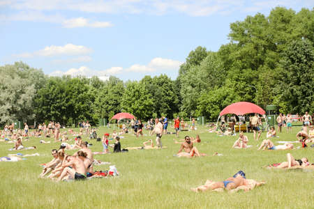 MINSK, BELARUS - 22 July, 2022: people sunbathing on the beach by the lake in the cityの写真素材