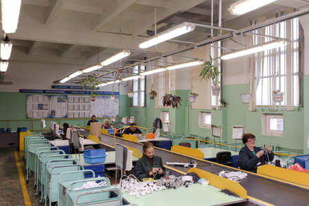 MINSK, BELARUS - 22 July, 2022: people with hearing disabilities work in a factoryの写真素材