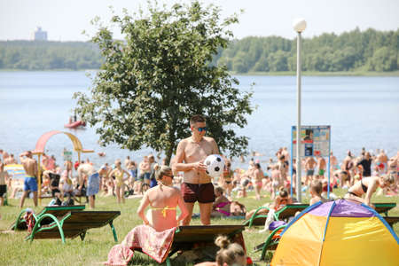 MINSK, BELARUS - 22 July, 2022: people sunbathing on the beach by the lake in the cityの写真素材