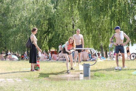 MINSK, BELARUS - 22 July, 2022: people sunbathing on the beach by the lake in the cityの写真素材