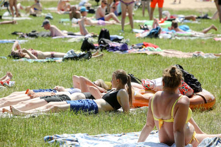 MINSK, BELARUS - 22 July, 2022: people sunbathing on the beach by the lake in the cityの写真素材