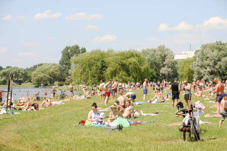 MINSK, BELARUS - 22 July, 2022: people sunbathing on the beach by the lake in the cityの写真素材
