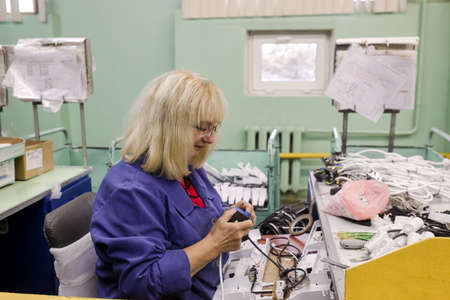 MINSK, BELARUS - 22 July, 2022: people with hearing disabilities work in a factoryの写真素材