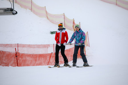 MINSK, BELARUS - 9 SEPTEMBER, 2022: trainer teaching snowboardingの写真素材