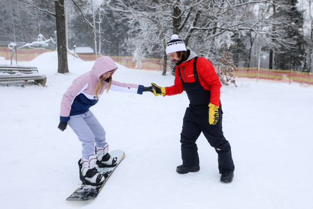 MINSK, BELARUS - 9 SEPTEMBER, 2022: trainer teaching snowboardingの写真素材