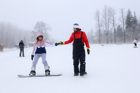 MINSK, BELARUS - 9 SEPTEMBER, 2022: trainer teaching snowboardingの写真素材