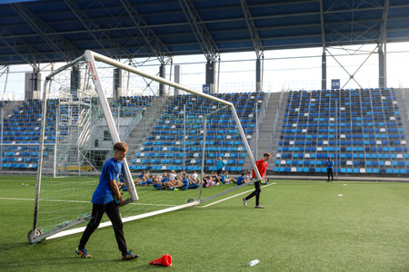MINSK, BELARUS - 9 SEPTEMBER, 2022: children train to play football in the stadiumの写真素材