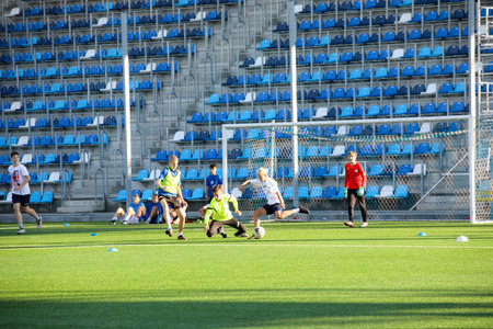 MINSK, BELARUS - 9 SEPTEMBER, 2022: children train to play football in the stadiumの写真素材