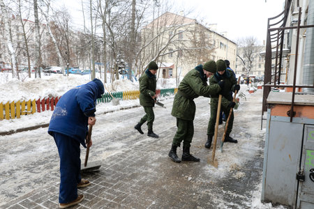 MINSK, BELARUS - 9 SEPTEMBER, 2022: soldiers clean the snowの写真素材