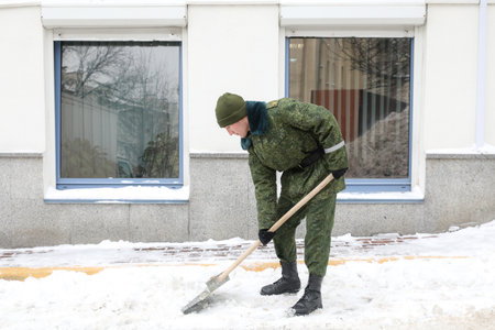 MINSK, BELARUS - 9 SEPTEMBER, 2022: soldiers clean the snowの写真素材