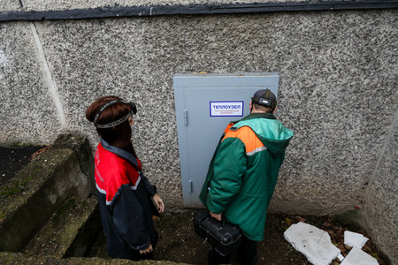 MINSK, BELARUS - 9 SEPTEMBER, 2022: girl plumber repairs pipesの写真素材