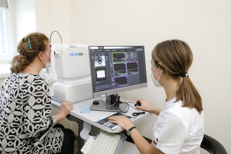 MINSK, BELARUS - 9 SEPTEMBER, 2022: ophthalmologist examining patient in eye hospitalの写真素材