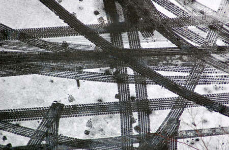 Car and humane traces on the fresh snow