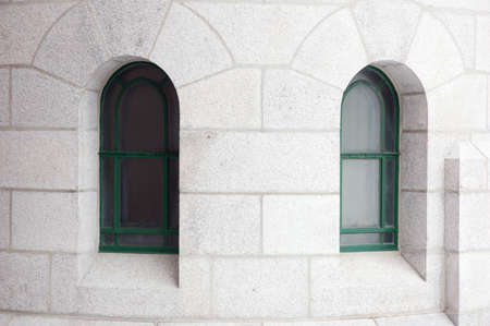Two glass windows in white brick wallの写真素材