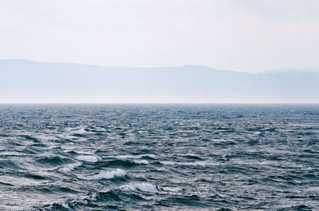 Sunbeam on dark sky above the sail boat on St. Lawrence riverの写真素材