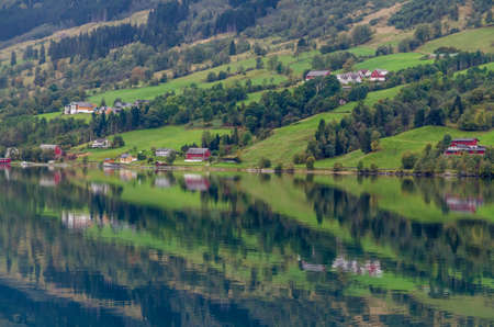Reflection in Norway fjord at fall time