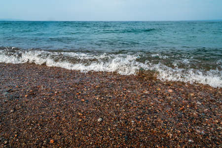 Surf on pebble beach of Superior Lake, Canadaの写真素材