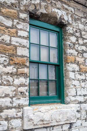 Window on stone wall in Toronto, Canadaの写真素材