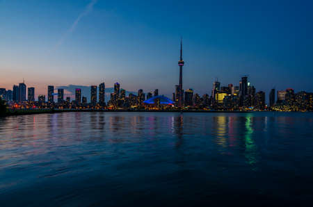 Skyline of Toronto over Ontario Lake after sunsetの写真素材