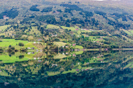 Reflection in Norway fjord at fall timeの写真素材