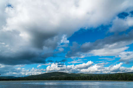 Rocky promontory in Superior Lake under blue cloudy sky. Canadaの写真素材