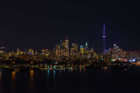 Skyline of Toronto over Ontario Lake at the night time.の写真素材