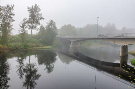 Strong fog above river at fall time. Norwayの写真素材