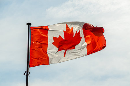 Canadian flag on sky and cloud backgroundの写真素材