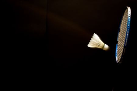 Racket and shuttlecock over blackの写真素材