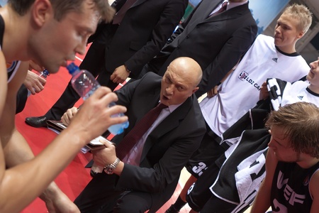SAMARA, RUSSIA - DECEMBER 23: Time out. Coach of BC VEF Ramunas Butautas says the game plan against BC Krasnye Krylia on December 23, 2011 in Samara, Russia.のeditorial素材