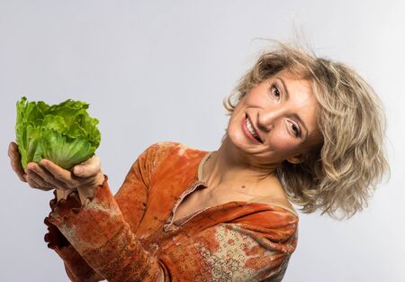 Beautiful woman with green cabbage, isolated on whiteの写真素材
