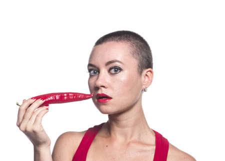 Woman with chili pepper on white backgroundの写真素材
