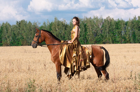 Antique style woman with horseの写真素材