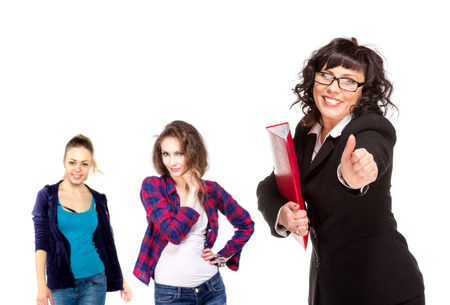Cheerful senior business woman with friends behind him giving thumb up, isolated on whiteの写真素材