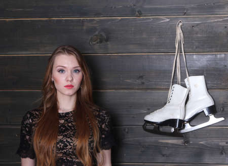 Woman and figure skates on hookの写真素材