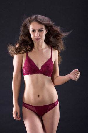 Attractive Sexy woman with beautiful body posing and wear red underwear isolated on gray background.の写真素材