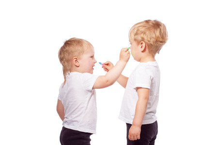 Children draw colored chalk on each other. Isolated on whiteの写真素材