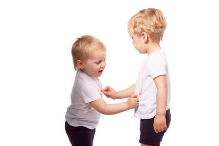 Children draw colored chalk on each other. Isolated on whiteの写真素材