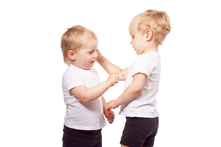 Children draw colored chalk on each other. Isolated on whiteの写真素材