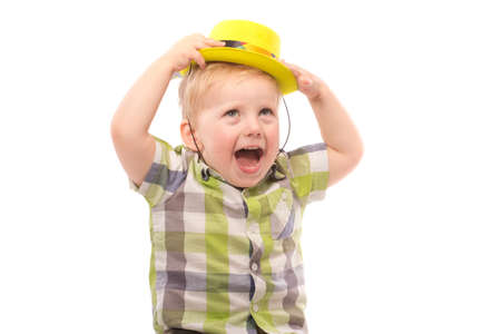 Little Funny boy in shirt and funny hat. Isolated on white backgroundの写真素材