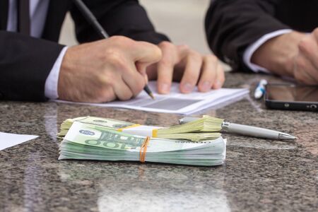 Business concept, mans hands signing papers. Selective focusの写真素材