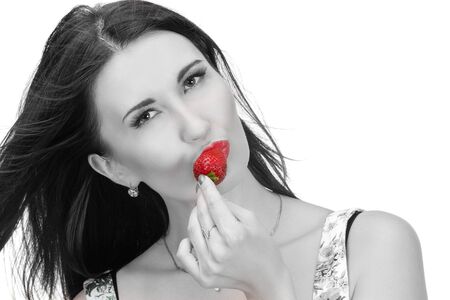 Pretty woman with strawberry in hand isolated on whiteの写真素材