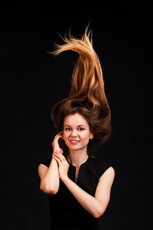 Close up Portrait of Young beautiful women with hair up trendy glamorous hairstyle. On black background.の写真素材