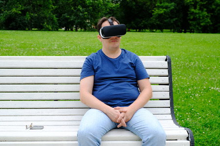Plus size man wearing virtual reality goggles outdoors First experience in 3d entertainment
